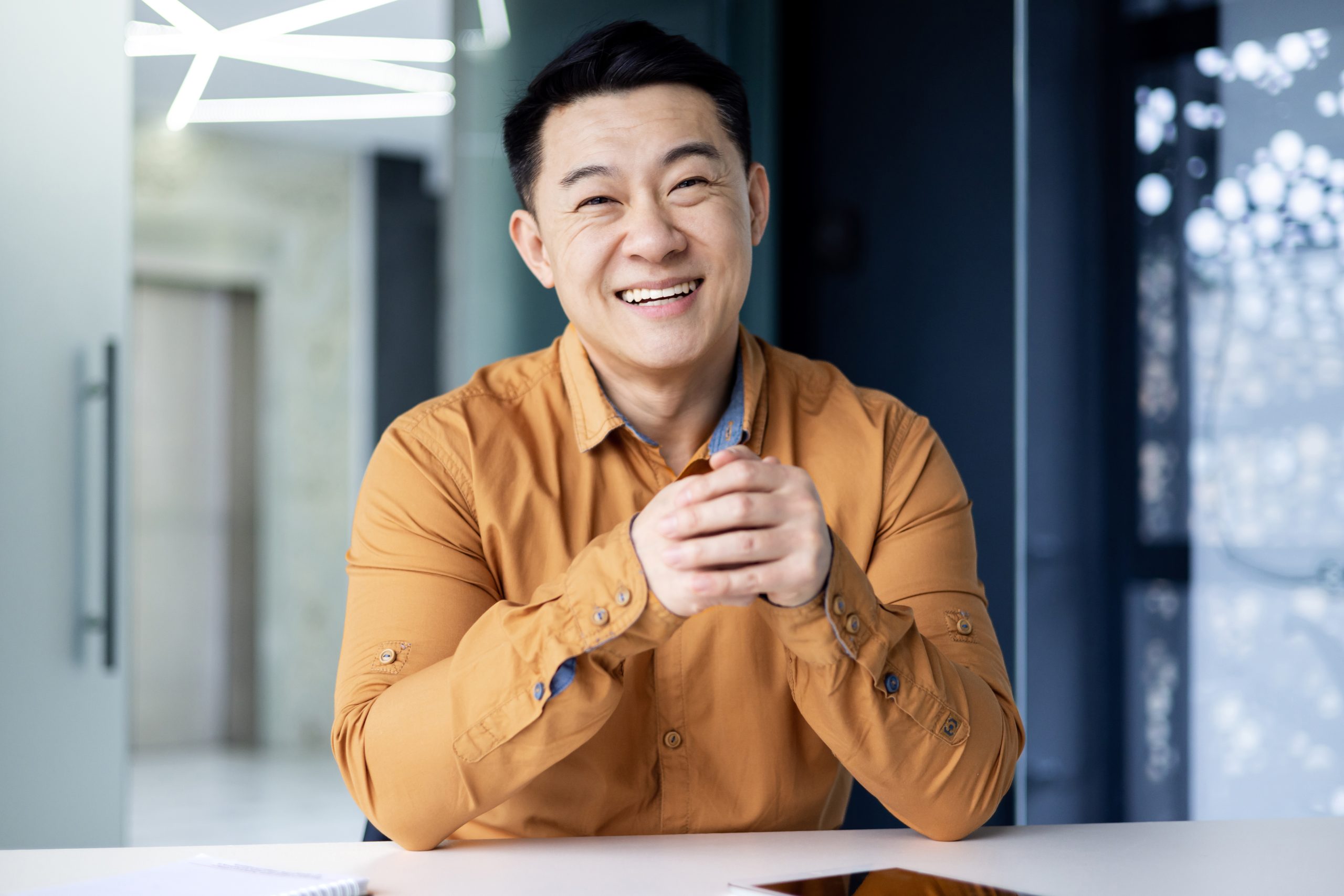 joyful-successful-businessman-watching-web-camera-smiling-man-talking-with-colleagues-remotely